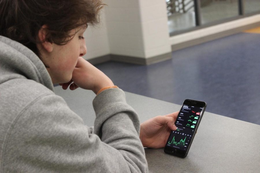 Junior Ethan Smialek keeping tabs on his stocks on the stock market. Photo courtesy of FCHS Journalism.