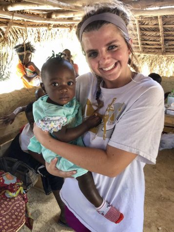 Chittenden holding a child she met in Cooperstown, Liberia. 