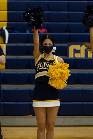A Lady Fluco cheerleader cheers on boys basketball in Oct. 2020.