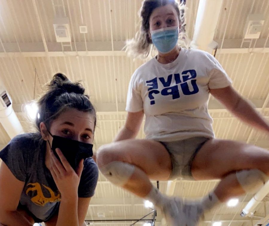 Two Lady Fluco volleyball players find fun in a world with masks.