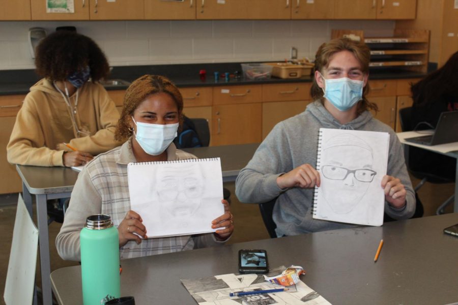Senior+Shayleigh+Sims+and+junior+Jacob+Morris+dont+let+masks+stop+them+from+drawing+in+Michelle+Colemans+art+class.