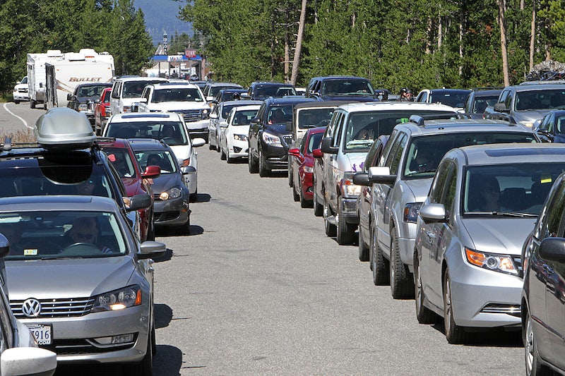 Vehicles lined up at West Entrance to Yellowstone National Park by Jim Peaco. Original public domain image from Flickr
