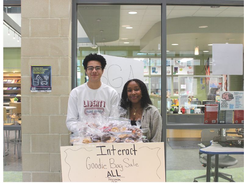 2 members of Interact Club Selling Goodie Bags for Rise Against Hunger