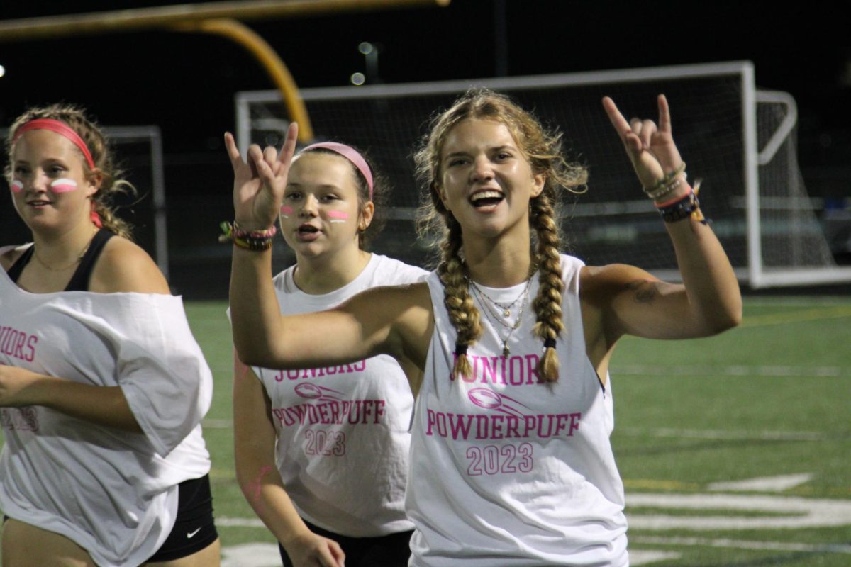 Juniors Ava Schwartz, Emily Cheripka, and Townes Mullinex celebrate after their win during the PowderPuff game on Oct. 2. 