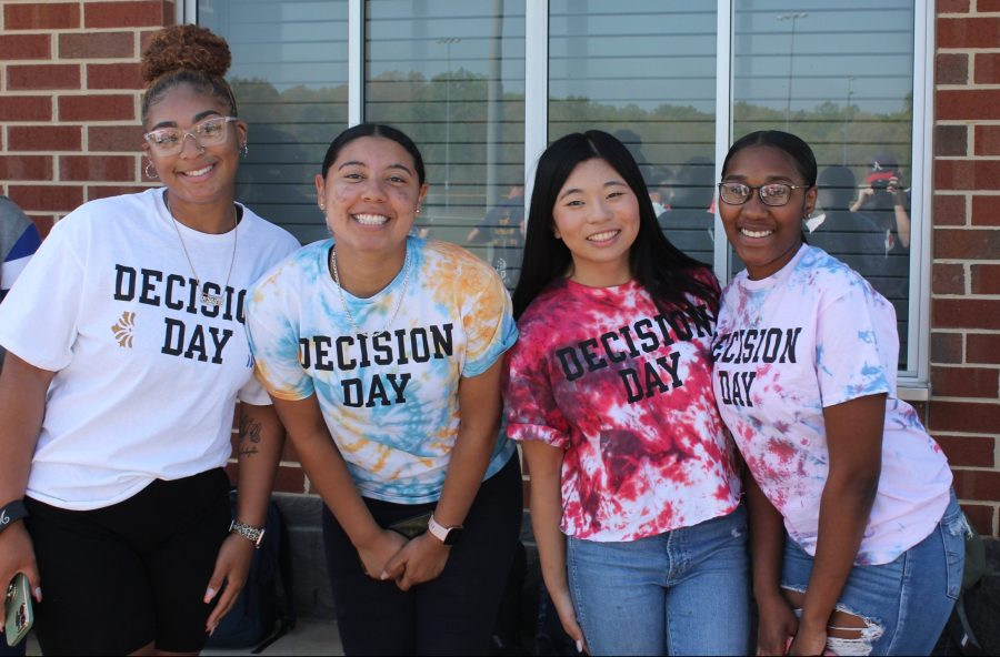 2022 graduates at the 2022 Decision Day show off their school colors in their tie-dyed shirts.