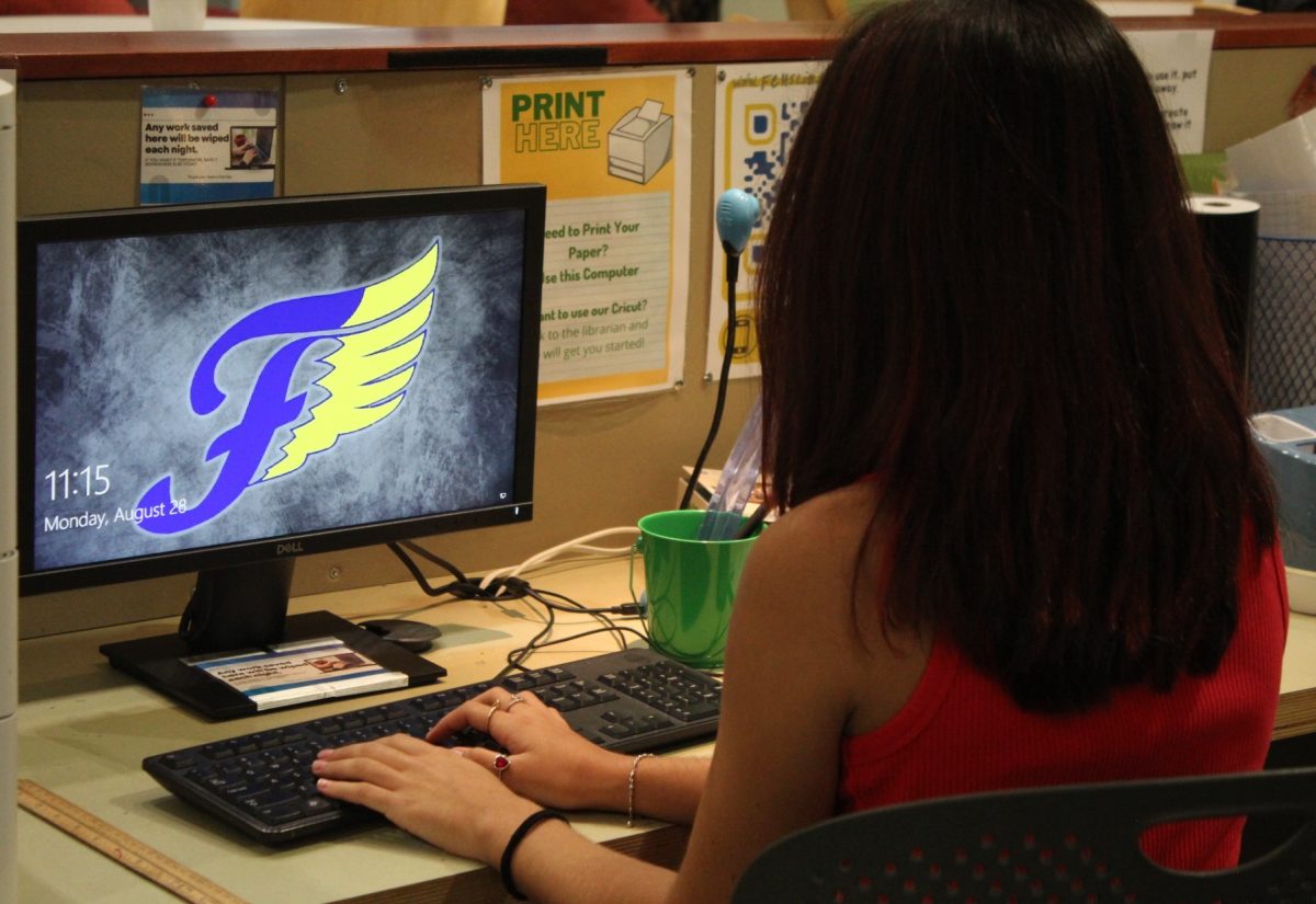 Sophomore student at FCHS logging into her computer to do an assignment.