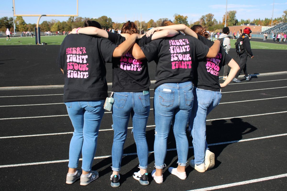 A group of FBLA students show off their Their Fight is Our Fight tees at the Oct. 25 Breast Cancer Walk on the track. Photo coutesy of Reece Matula. 