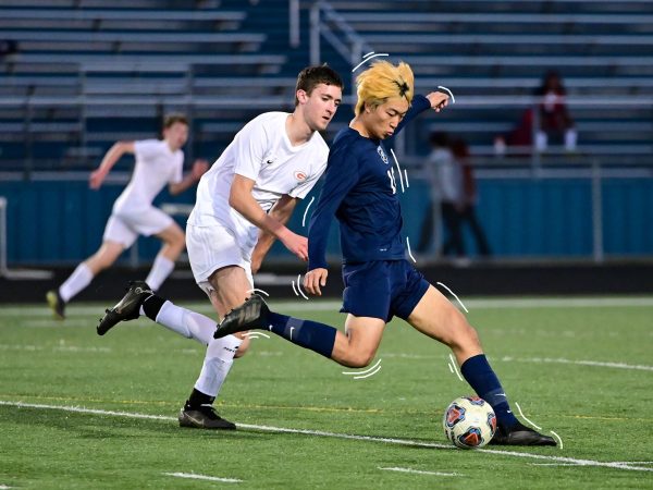 FCHS senior Joseph Yoo pursued by a Goochland player at the March 20, 2023 varsity boys soccer game at FCHS. Photo courtesy of Fluvanna Sports Photography.