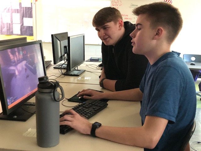 Robert Matics watches Hagan Porter play a competitive game of Overwatch at an Esports practice for the 2023 season. Photo courtesy of Fluco Journalism.