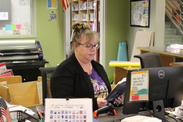 FCHS, librarian Shannon Taylor, reads as she works at her desk in the library. Photo courtesy of Jennifer Wyant. 