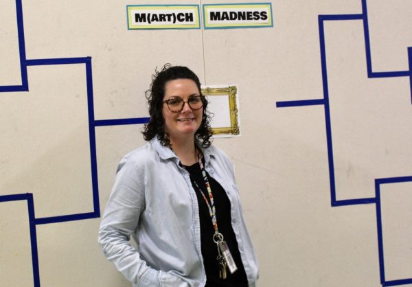 Art teacher Michelle Coleman shows off her M(art)ch Madness bracket board outside of her classroom. Photo courtesy of Jennifer Wyant.