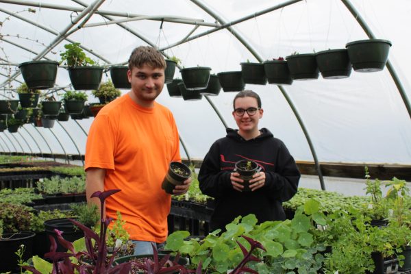 Madison Lewis 24 with Logan Russell Inskeep 24 gardening in the greenhouse. Photo courtesy of Fluco Journalism.