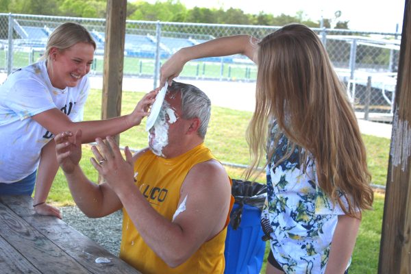 Teacher Jason Barnett gets a pie in the face from some seniors at the 2023 Decision Day festivities. 