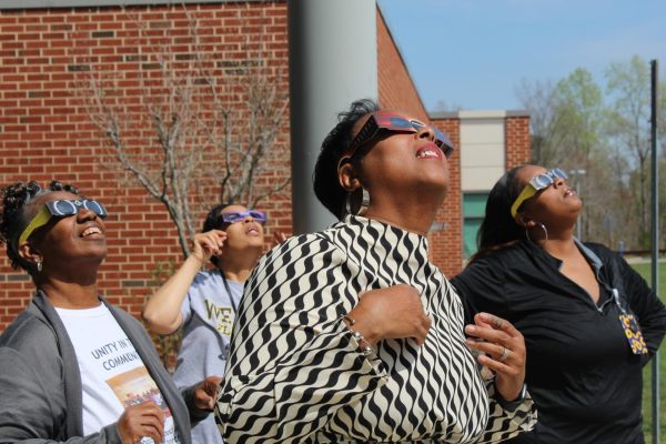 Kessler, lets put this up today for Photo of the week. L-R: Front office staff Ethel Opie, Angela Brown, Principal Margo Bruce, and Victoria Harris watch the eclipse at 2:45 on April 8.  Photo courtesy of Elizabeth Pellicane. 