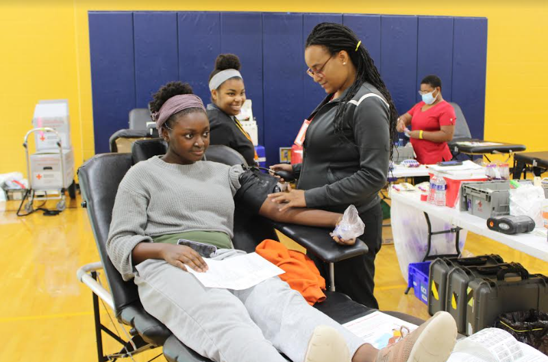 Senior Heritage Ibie (left) has her blood taken by a Red Cross Phlebotomist at the Sept. 19 FCHS Blood Drive.