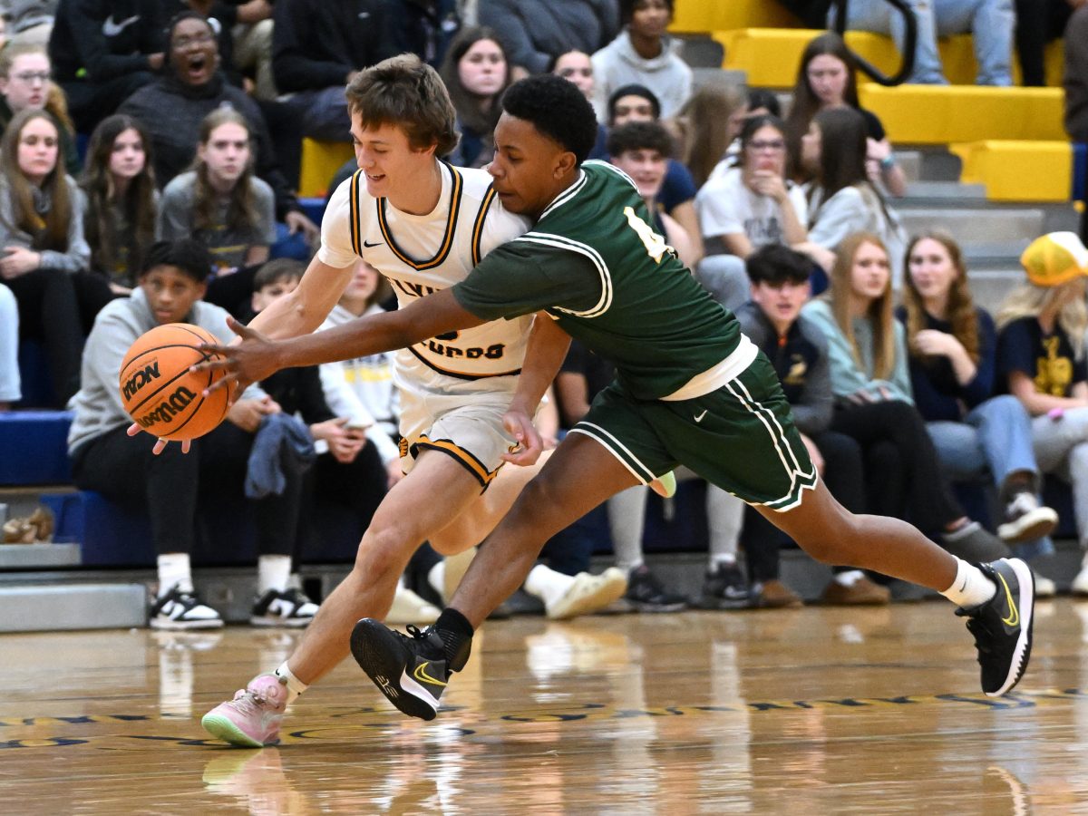 Fluco Samuel Loving takes on a Louisa player at a Dec. 11, 2023 basketball game.