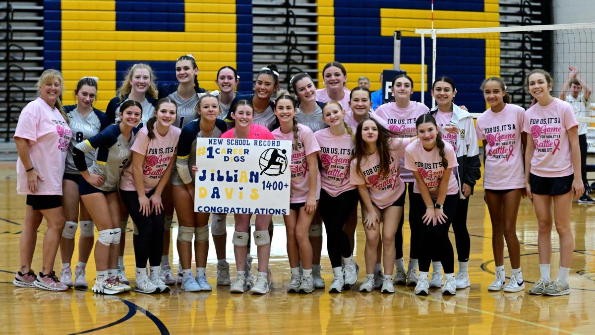 The varsity volleyball team celebrating Jillian Davis who broke the school volleyball digs record on Oct. 17.