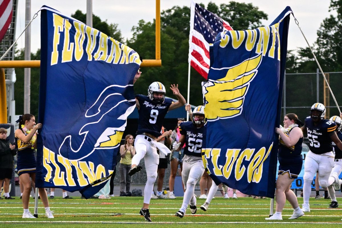 The varsity team makes their entrance on the field at the Aug. 31 game against Broadway at home. Photo courtesy of DLH Sports Shots.