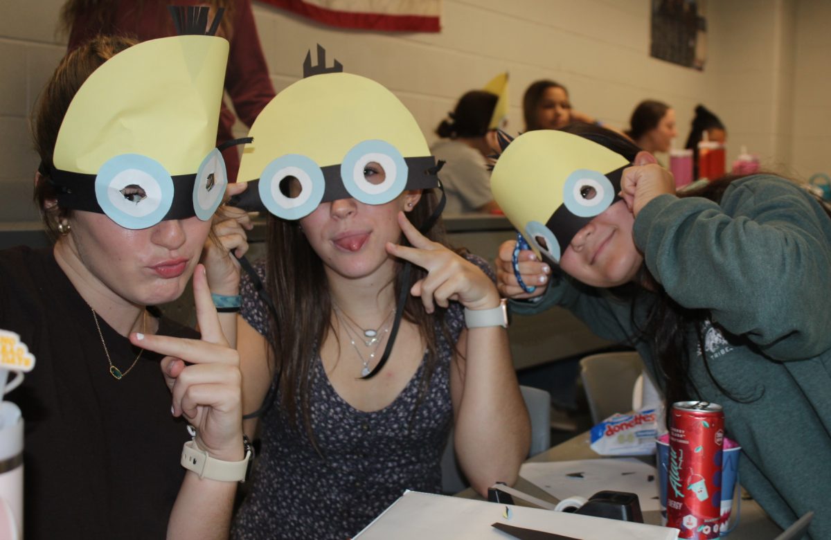 26' Ryllen Beasley, Sophie Pace, and Margeaux Cantagallo pose with their Minion creations.