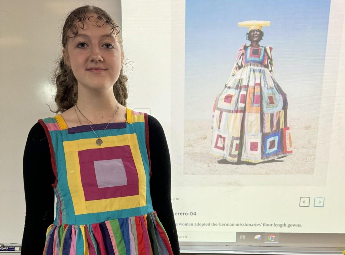 Sociology student Greenlee Sensabaugh in a dress she designed and sewed for Sociology class to represent the effect of German colonization on the Herero tribe in Africa.