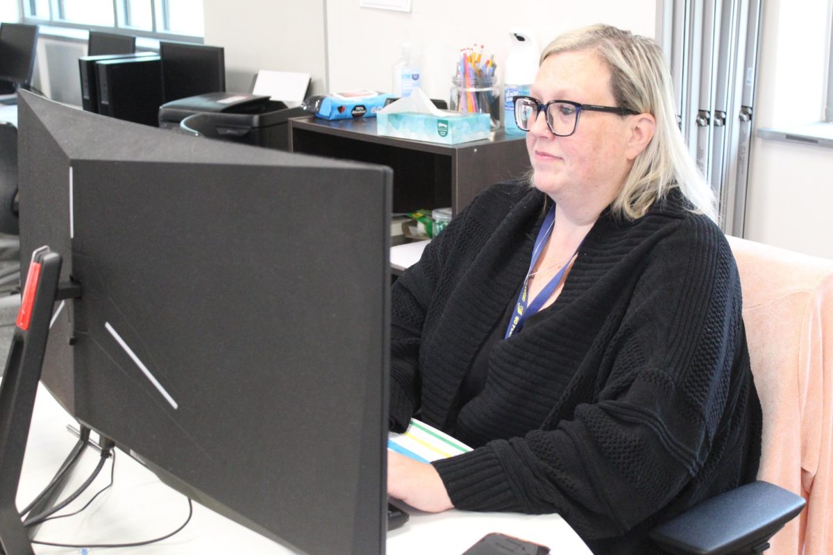 Crystal Cutright works on her computer, monitoring her students during online classes and making sure they stay focused and on track.