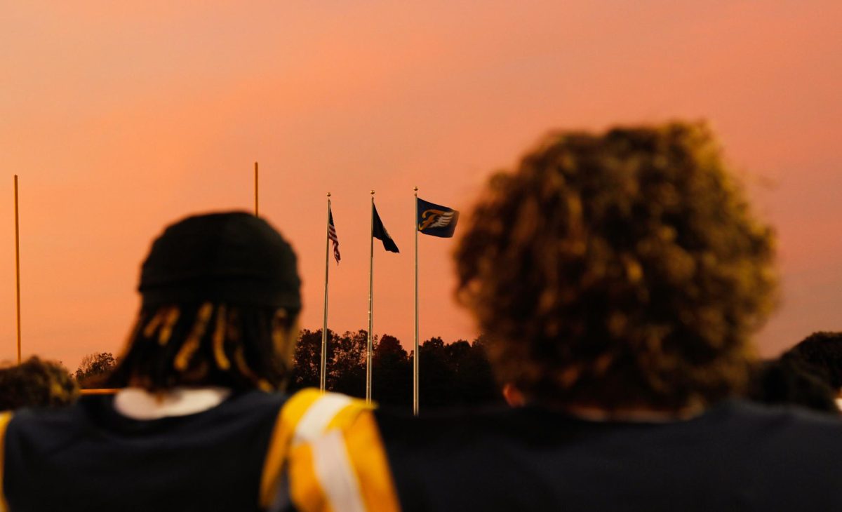 Fluvanna football players look towards the Fluvanna flags.