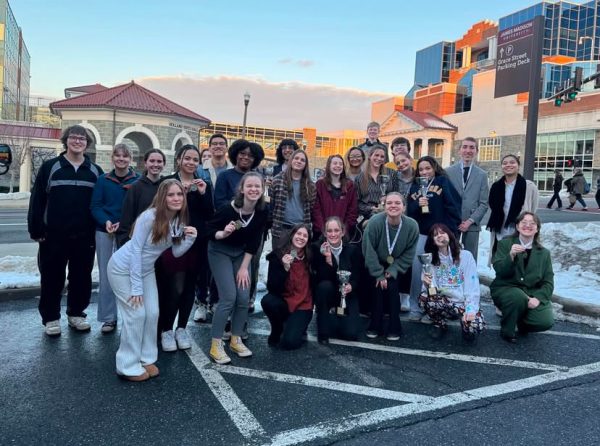 FCHS's speech and debate teams pose in front of James Madison University after the Shenandoah Valley Forensic League Championships. 