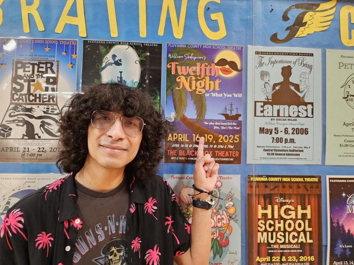 Second lead actor Tomas Cruz-Vega poses with a Twelfth Night poster. 