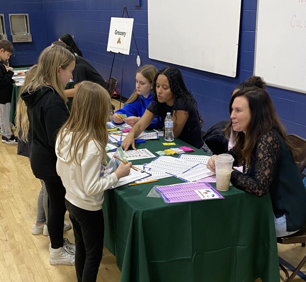 Beta members share a marketplace activity with students at Central Elementary. 