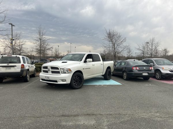 Truck parked taking up 2 spots in the senior parking lot. 