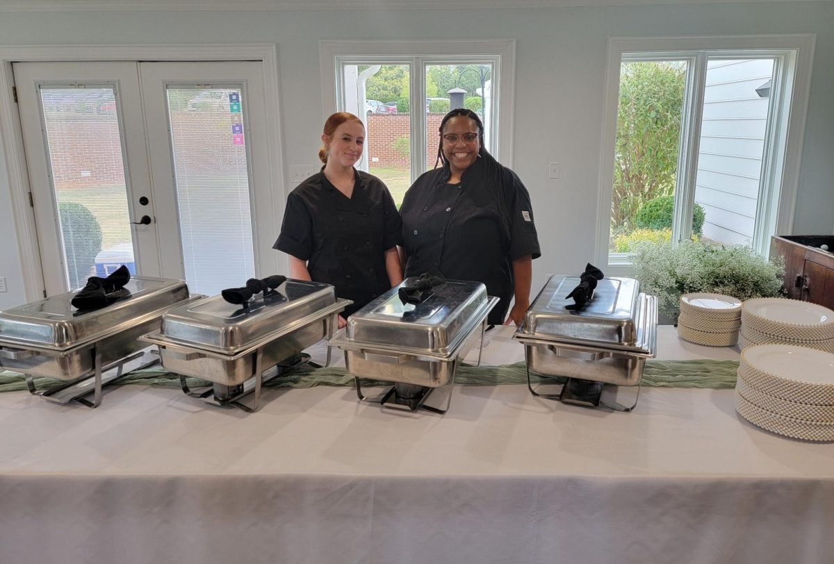 Chef Grooms and her apprenticeship student Carly Brown at a wedding they catered. 