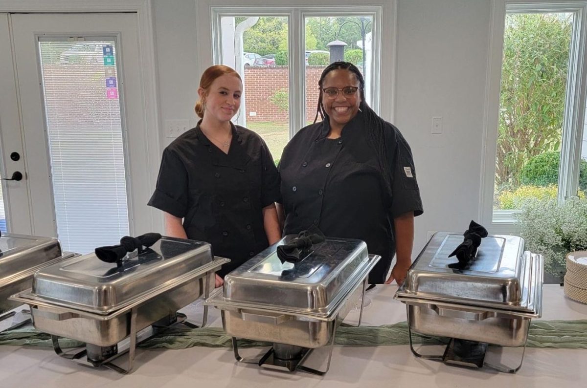 Chef Grooms and her apprenticeship student Carly Brown at a wedding they catered. 