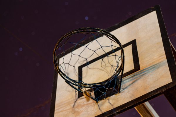 A basketball hoop at night. Photo courtesy of Dhyamis Kleber at Shutterstock.com. https://stocksnap.io/photo/old-basketball-WGWCPKSQUJ 