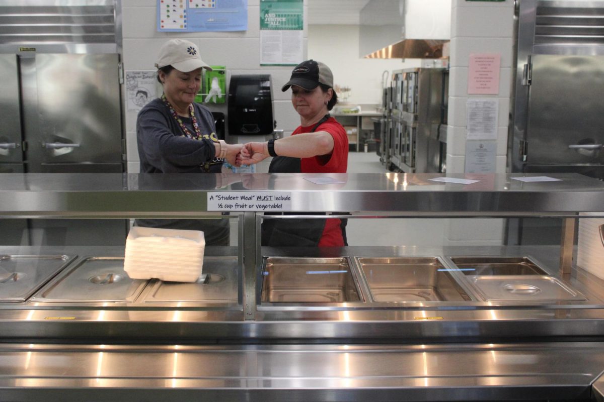 Sheri Casero and Holly Brown are looking at their watches, waiting for students to get longer lunches. Photo courtesy of Carson Johnston.