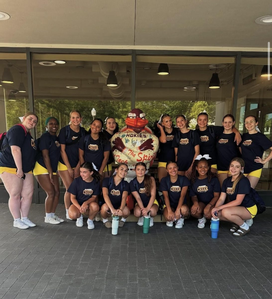 Fluvanna cheer team pose with Virginia Tech's HokieBird.