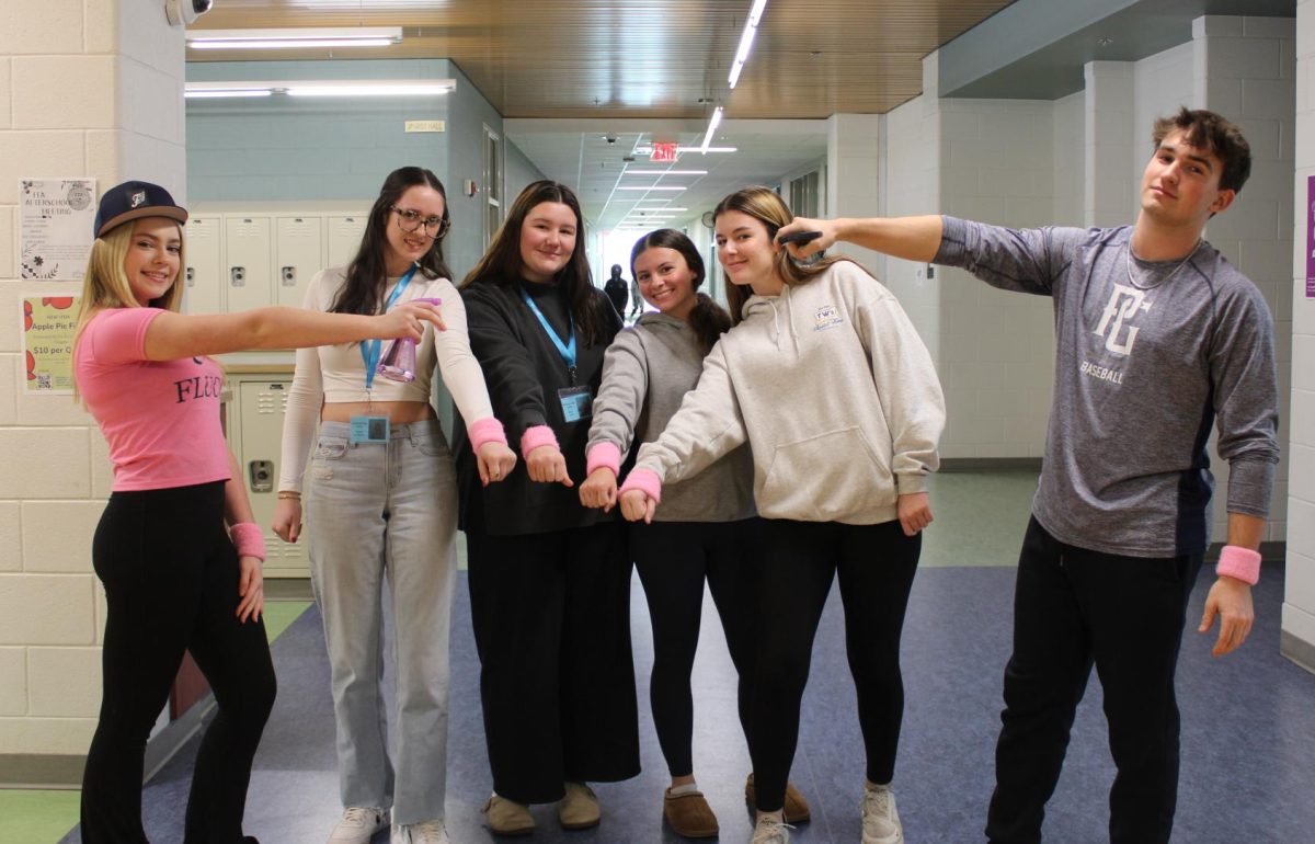 Seniors Mikaela King, Carson Johnston, Molly Cook, Ryllen Beasley, and Carson Raines pose with their winter assassin water bottles and wristbands.
