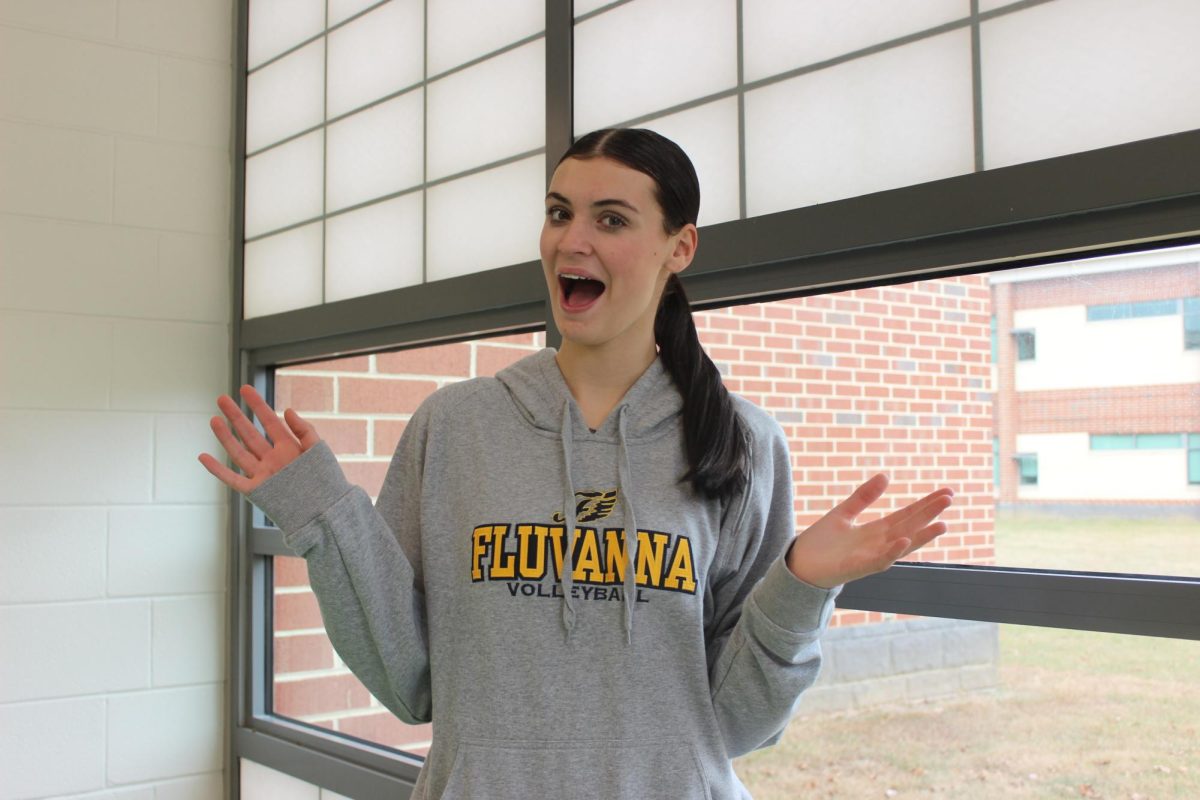 Senior Molly McCall sings in front of the window.