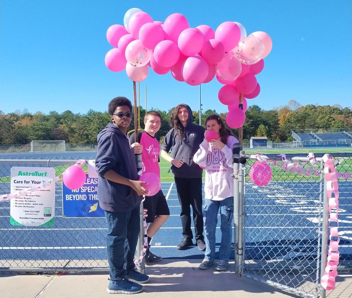 Four FBLA members on the FCHS track for the 2024 Breast Cancer Walk.