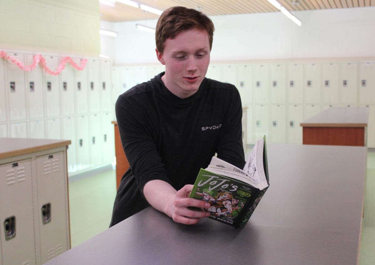 A student reads a "Jojo's Bizarre Adventure" manga in the locker bay.