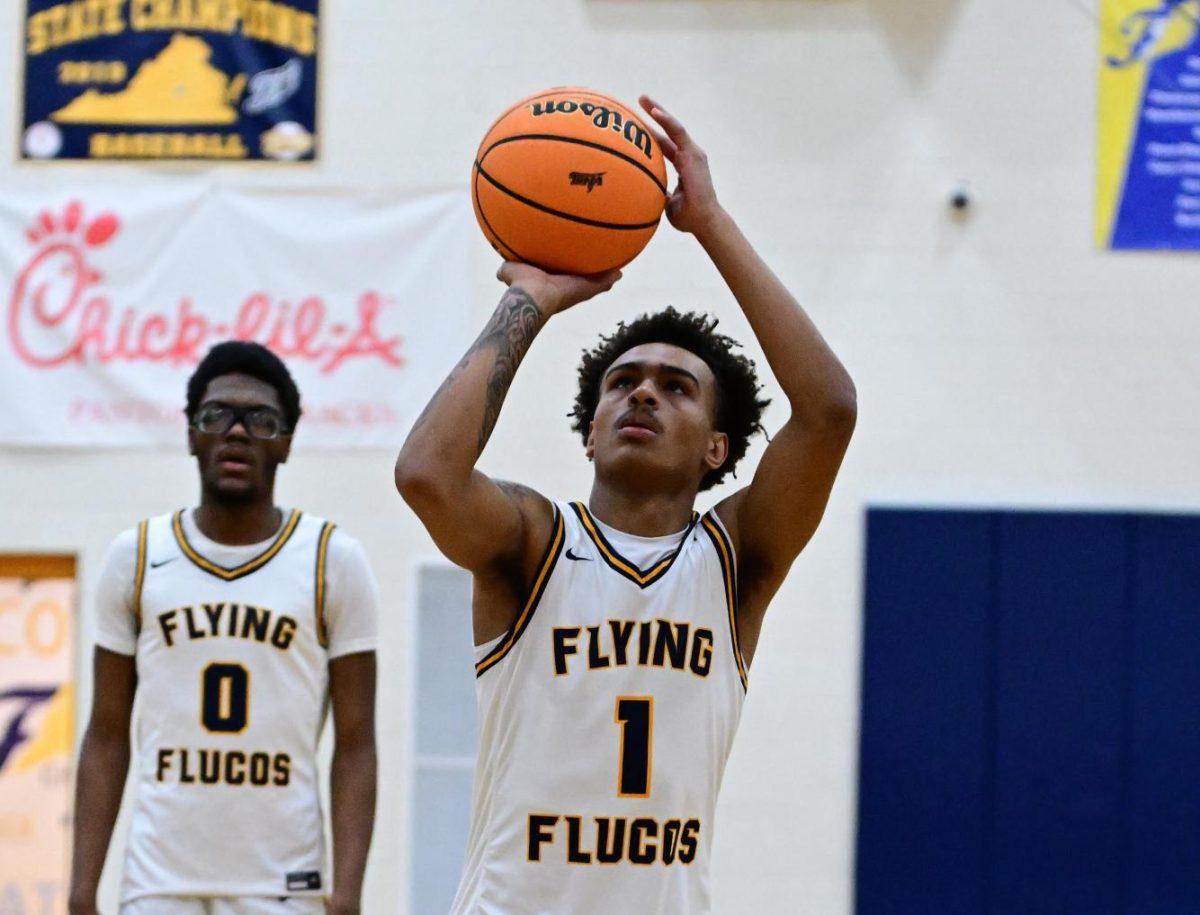  Junior Antwon Carter #1 (right) at a home basketball game with senior Andre Key #0. 