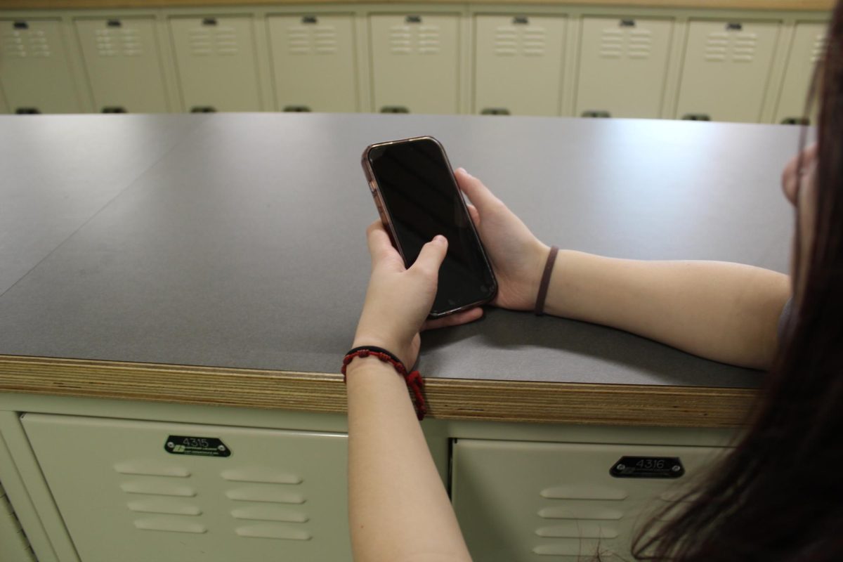 Student on phone in hallway.