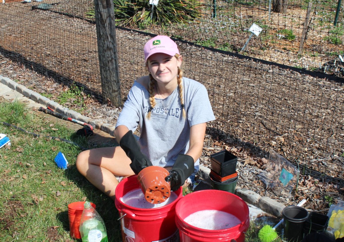 FCHS Graduate Riley Graziano washing community park plant pots for last year's Hands on Fluvanna. 