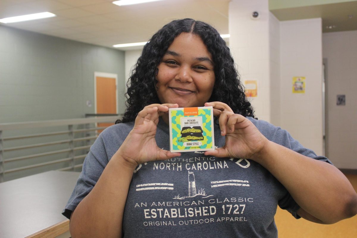 Senior Ladaisha Tinsley holding up a Dubai chocolate bar.