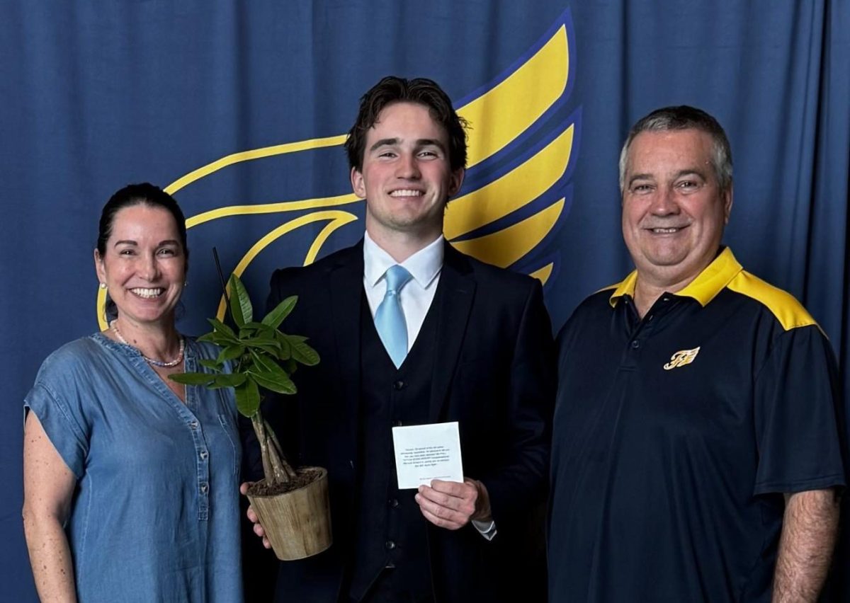 Carson Raines with his scholarship notification and money tree, alongside his parents, Carey Nestor Raines and Ernie Raines.
