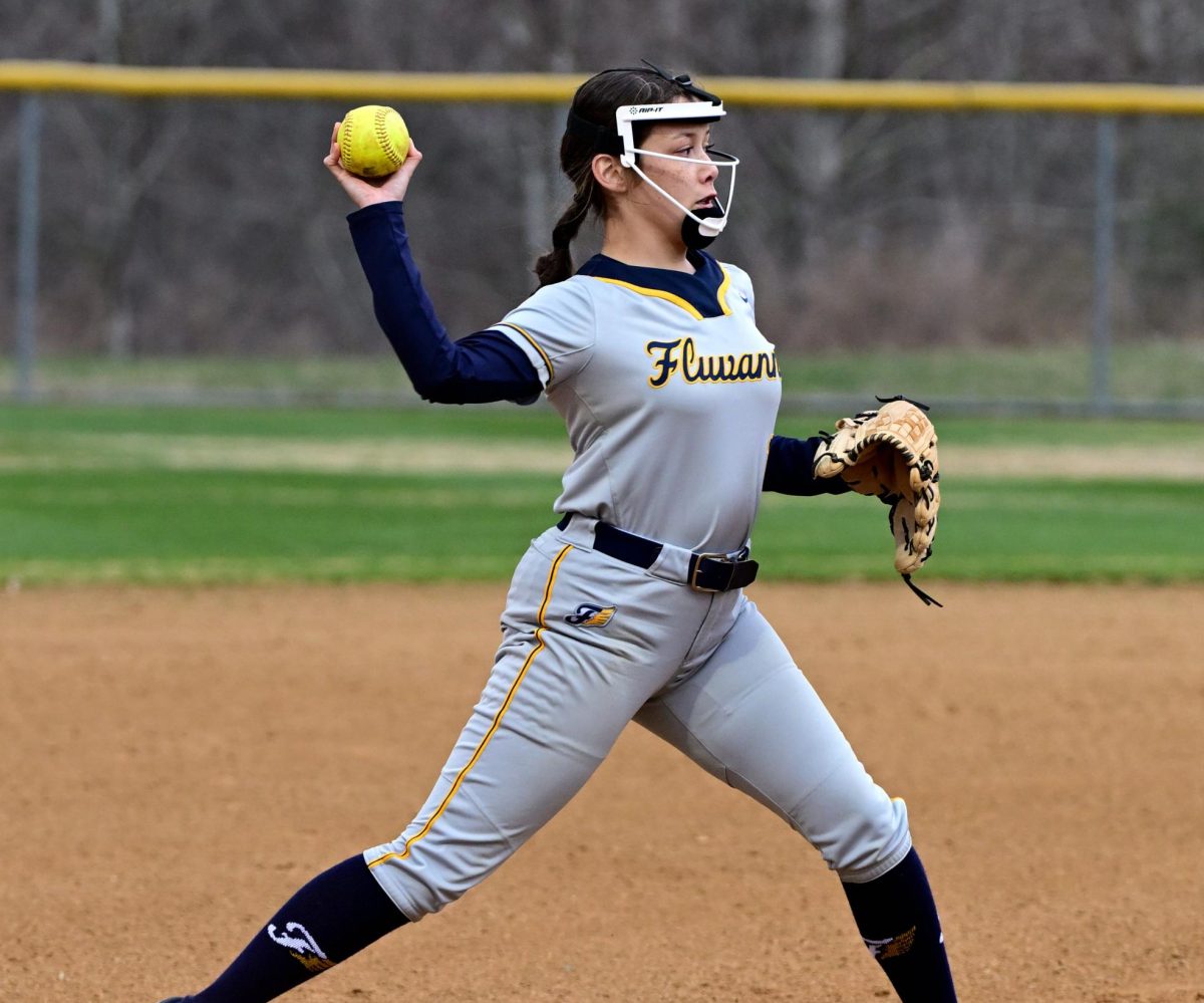 Varsity player Natalie Gomez throwing a pitch.
