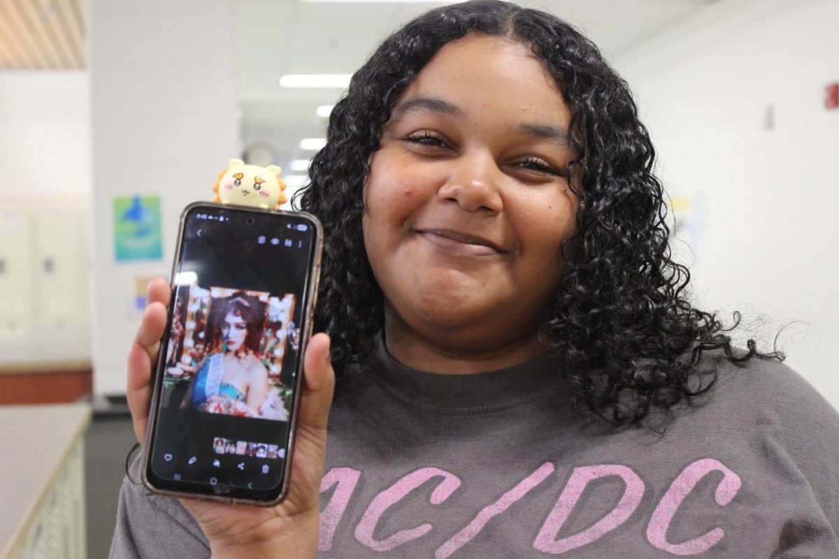 Senior Ladaisha Tinsley holding up photo of Chappell Roan