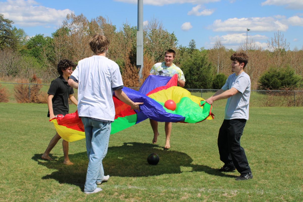 Seniors Joaquin Mendoza, Topher Huff, and Kevin Sloan play a game at the April 30 Decision Day event.
