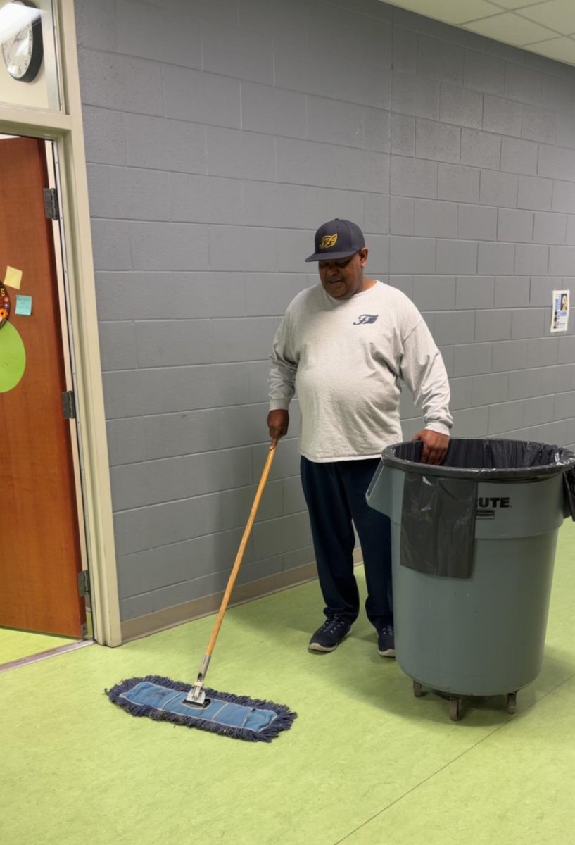 FCHS Custodian Robert Bryant sweeps the hallways. 